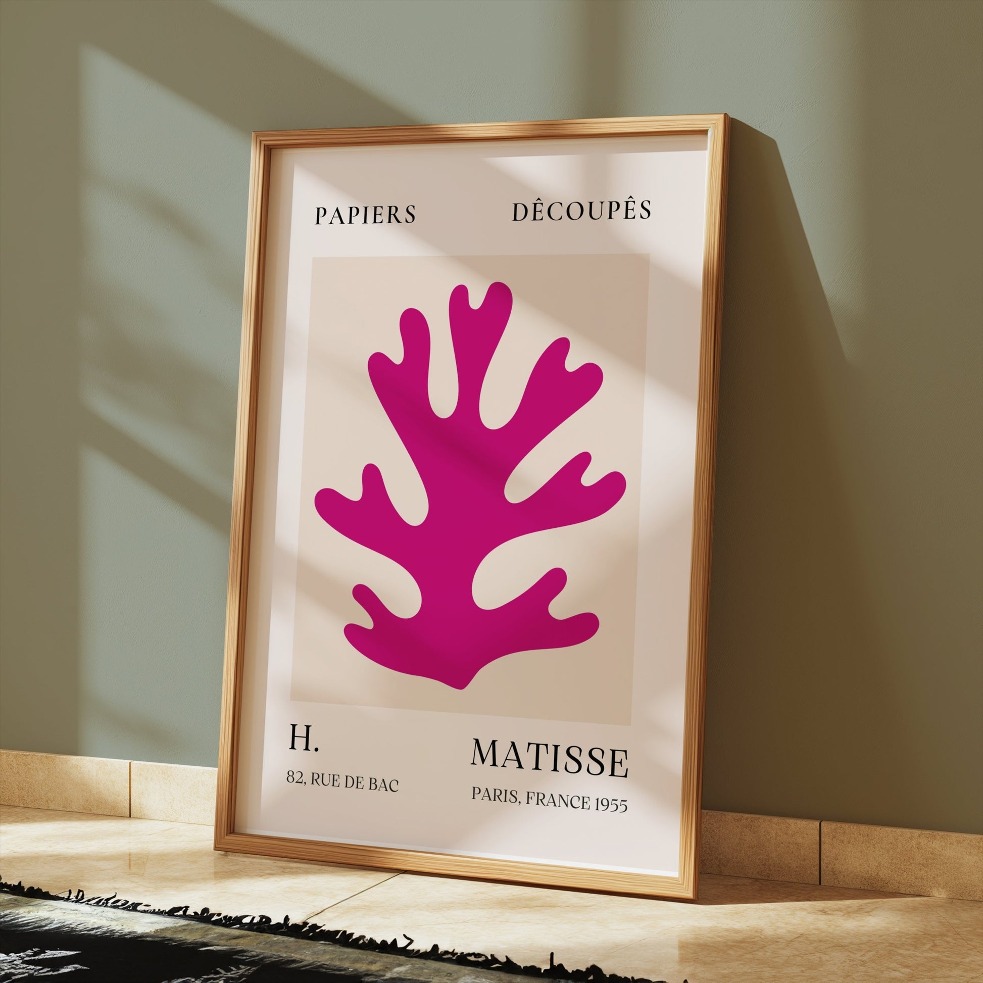 Vintage Papiers Découpés poster by H Matisse, France 1955, framed and displayed on a tiled floor with sunlight streaming through.