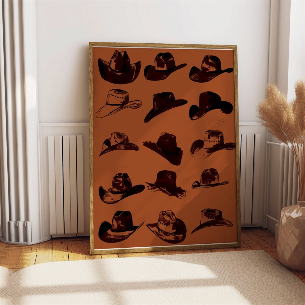 Vintage cowboy hats art poster leaning against a wall in a sunlit room, paired with pampas grass in a vase for a rustic aesthetic.