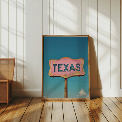 Rustic Texas retro sign wall art with a pink and blue design, framed and placed on a wooden floor in a minimalist space.