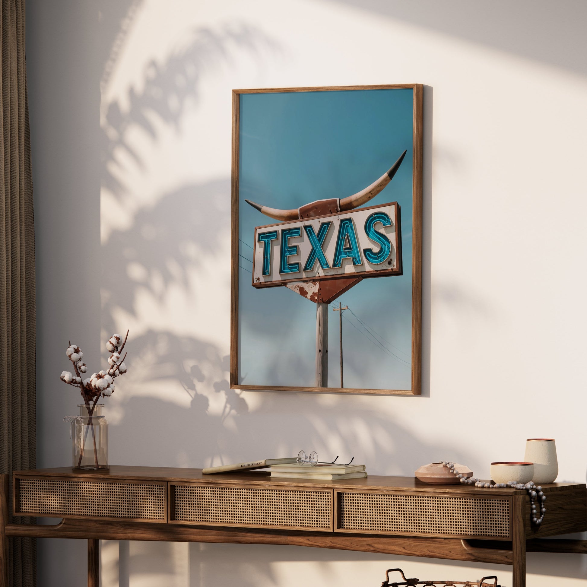 Rustic Texas roadside sign art print in a wooden frame, styled on a console table with decorative accents in a softly lit room.