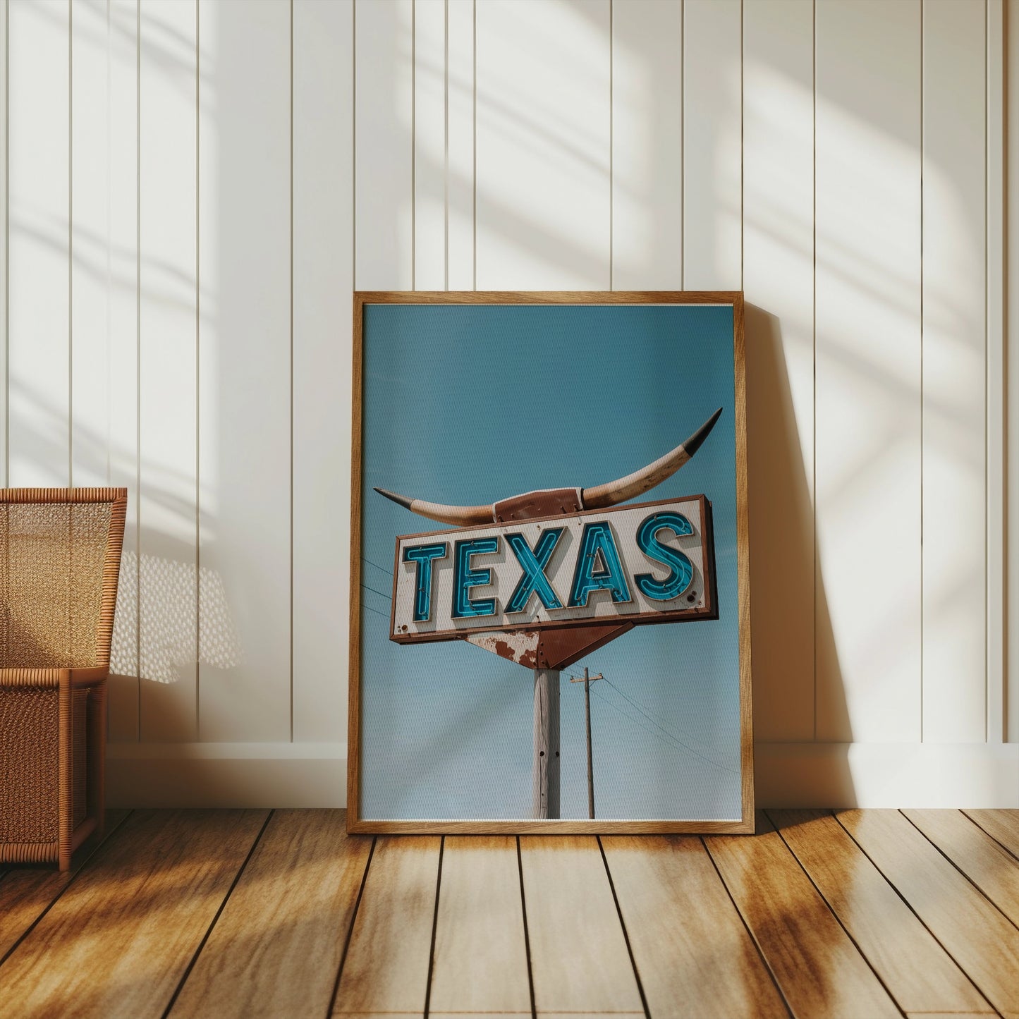 Vintage Texas roadside sign art print in a wooden frame, propped against a white paneled wall in a bright, rustic space.