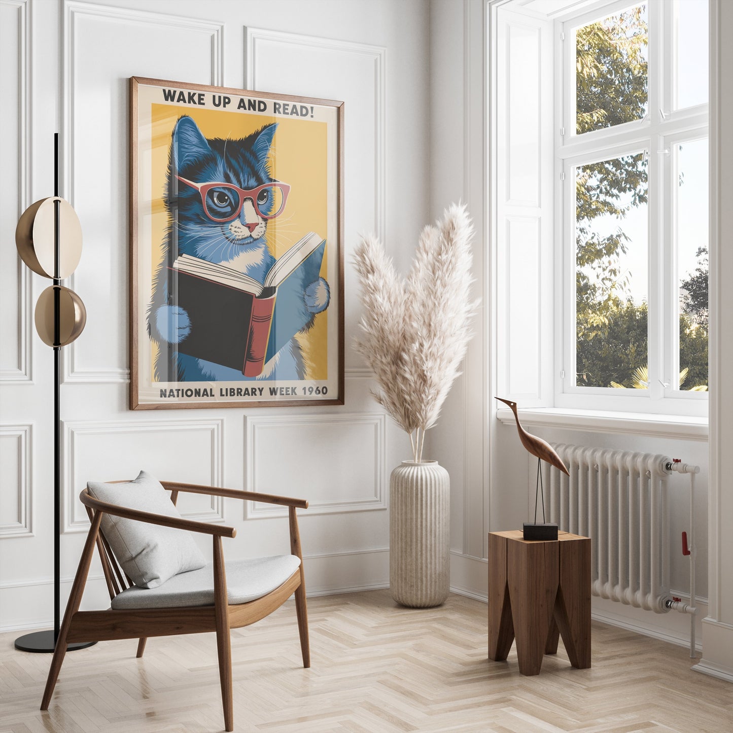 Stylish room featuring a framed 'Wake Up and Read!' cat poster on a white wall, paired with modern furniture and pampas grass decor.