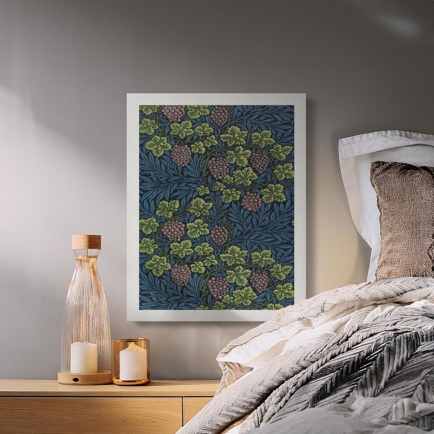 William Morris Grape Vines canvas wall art styled in a cozy bedroom with neutral bedding, candles, and soft lighting for a vintage decor touch.
