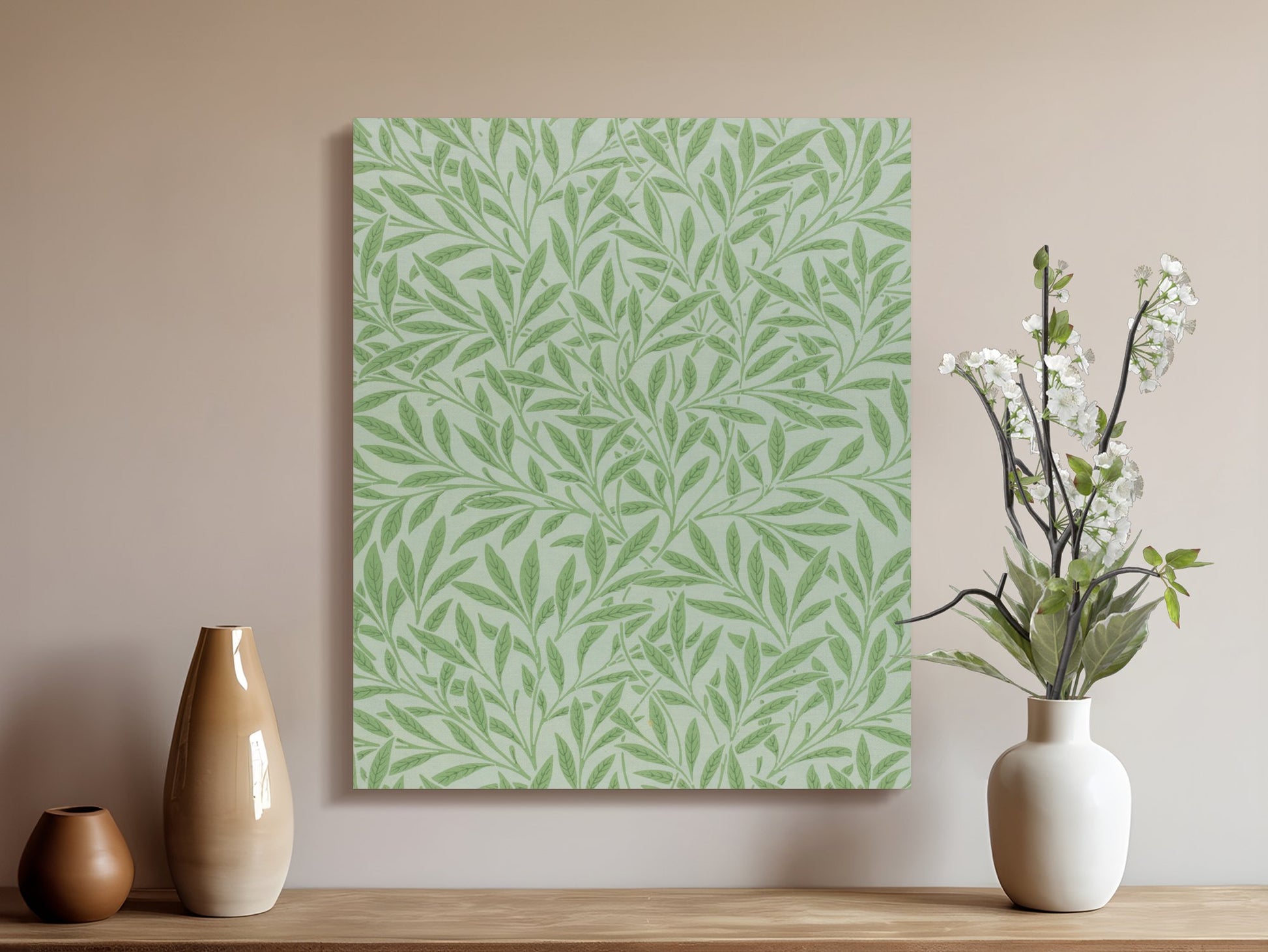 William Morris green leaf pattern canvas wrap styled on a wooden shelf with vases and flowers, perfect for botanical wall art.