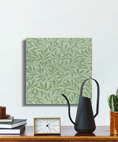 William Morris green leaf pattern canvas wrap placed on a desk with minimalist decor, ideal for office or home wall art.