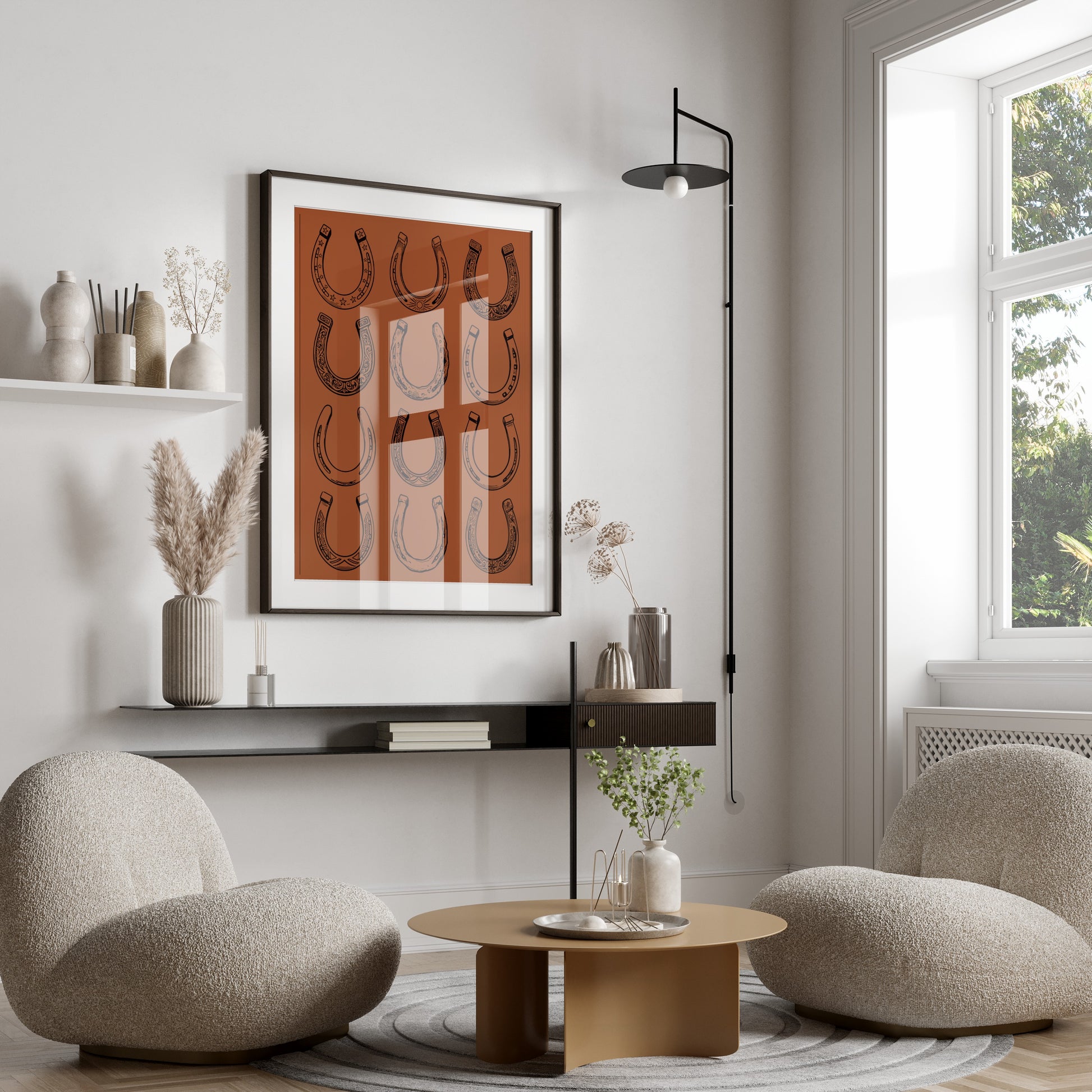 Framed artwork of repeating horseshoes hangs above a modern living room seating area.