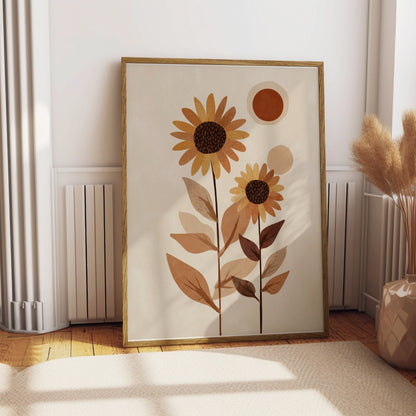 Abstract sun and sunflowers artwork in a framed print on a wooden floor.