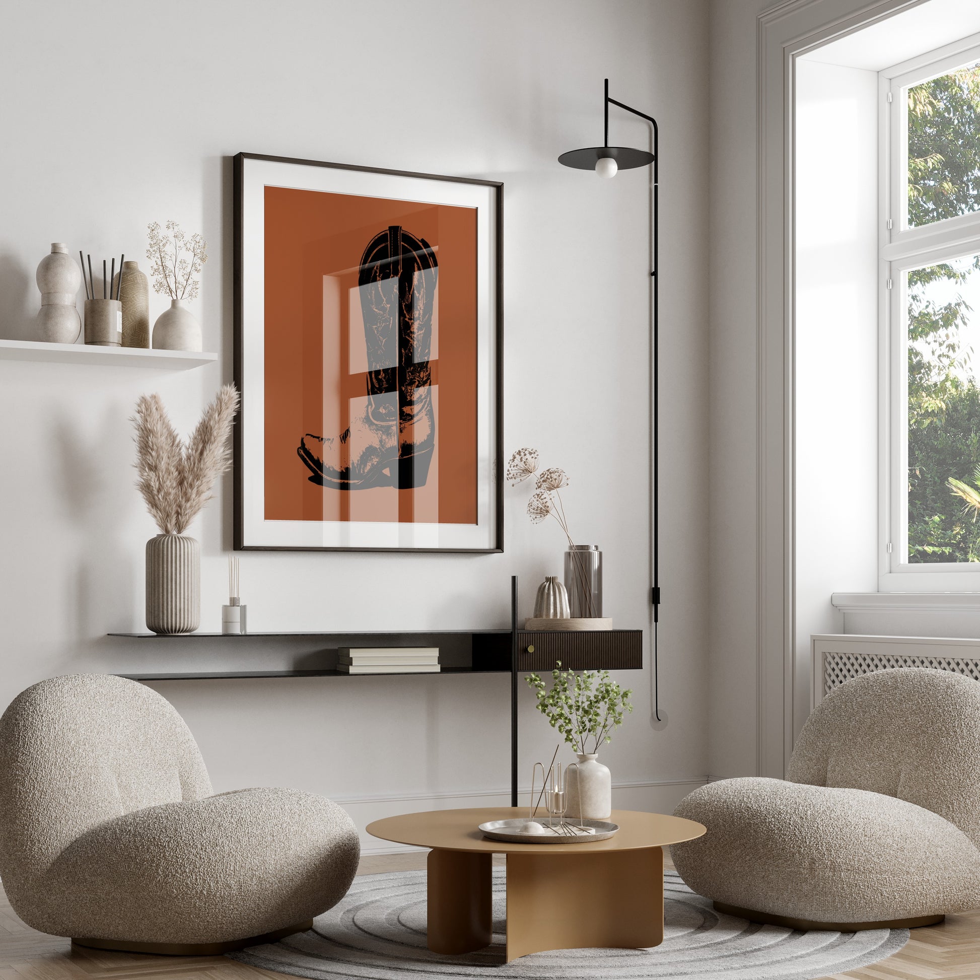 Framed abstract art of a boot on a burnt orange background hangs above chairs.