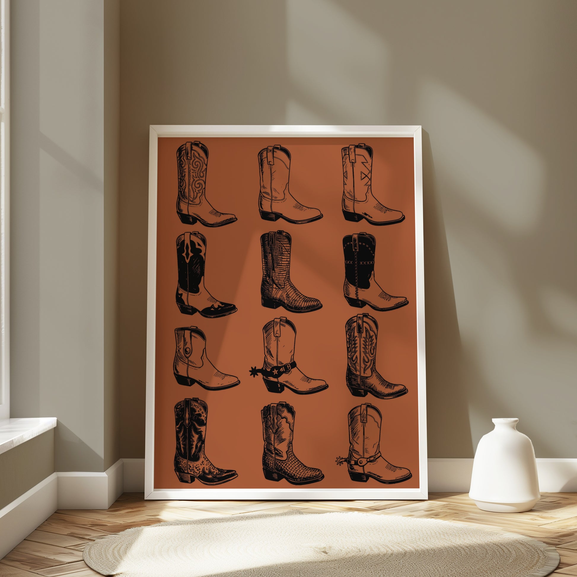 Framed illustration of twelve cowboy boots on a wall.