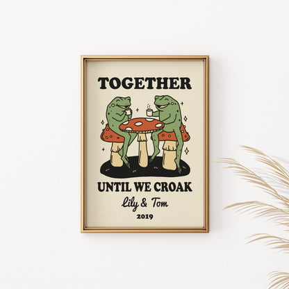 Framed print of two frogs drinking coffee on mushrooms, text reads "TOGETHER UNTIL WE CROAK Lily & Tom 2019".