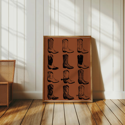 Framed artwork displays twelve black and white cowboy boot illustrations on a brown background.