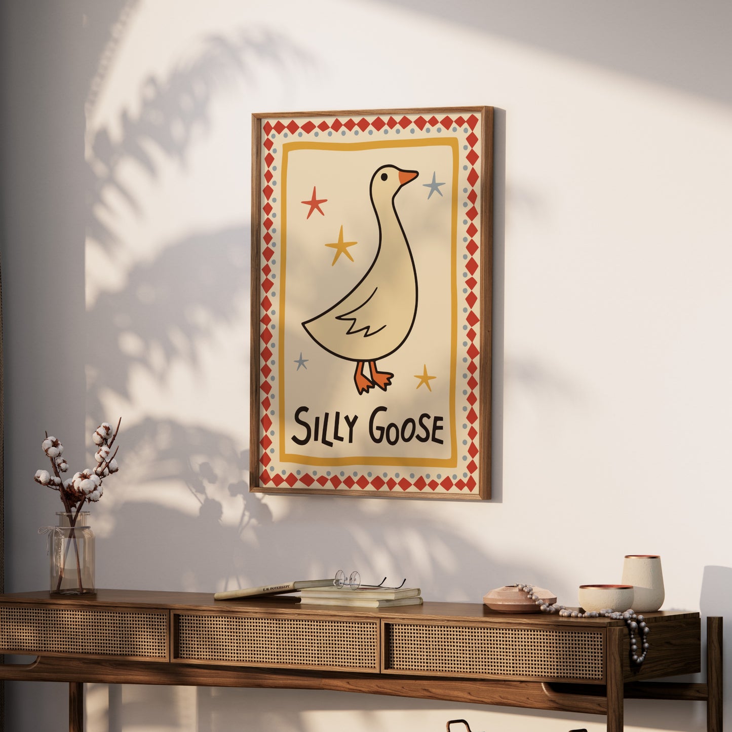 Framed "Silly Goose" artwork with a cartoon goose and stars.