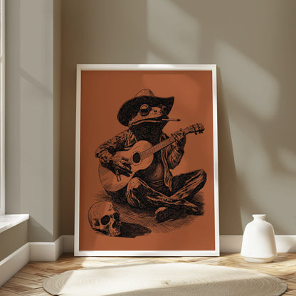 Frog wearing a cowboy hat playing guitar next to a skull.