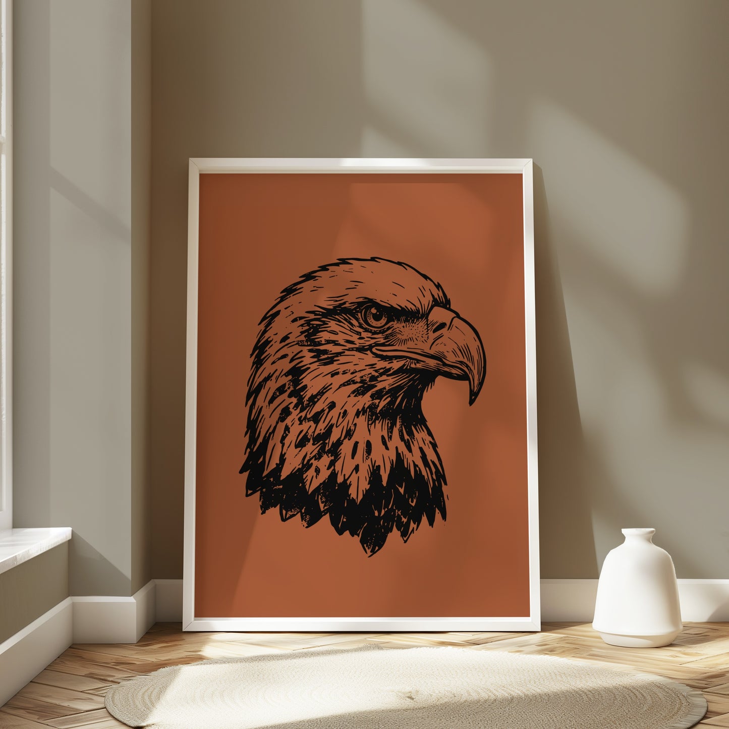 Framed black ink sketch of an eagle's head on burnt orange background.